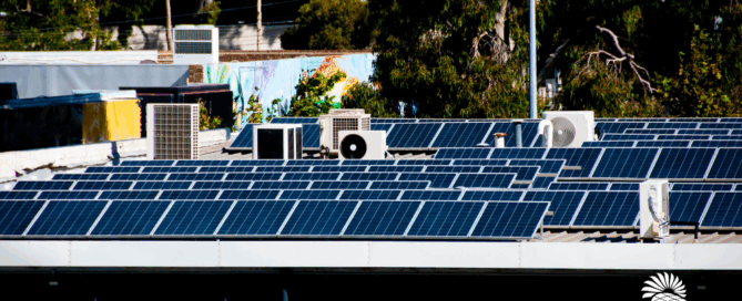 Commercial building with solar panels installed on the roof, reducing energy costs with Sun Energy Today.