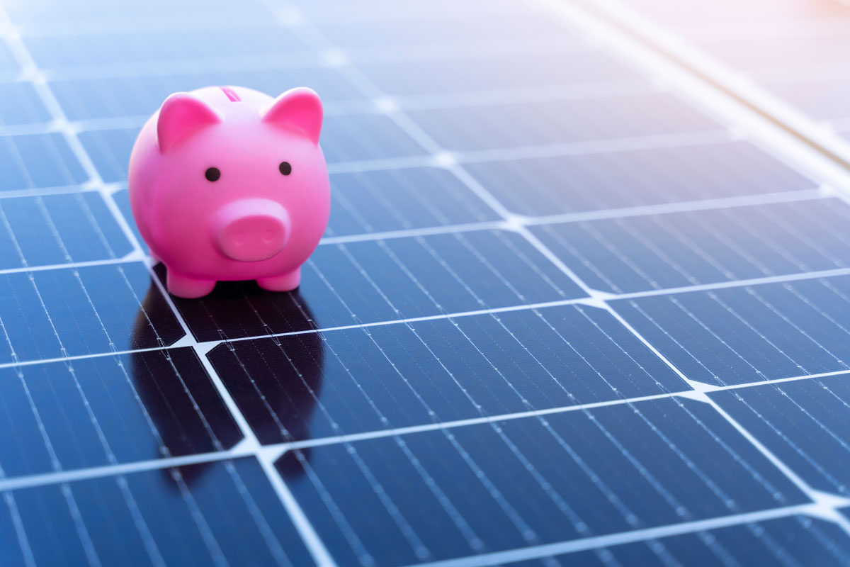Pink piggy bank on solar panels representing Sun Energy Today’s residential solar incentives, highlighting energy savings and affordable clean power for homeowners.